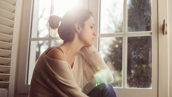 depressed woman by the window