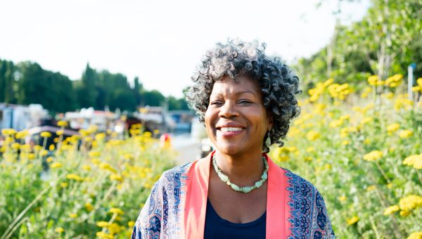 Someone smiling and walking in a field
