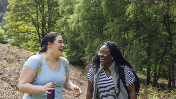 happy friends hiking in woods