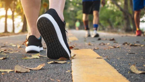 close-up of sneakers walking on pavement