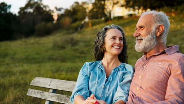 happy mature couple sitting outdoors
