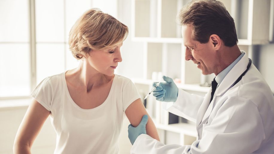 Doctor giving patient a vaccine