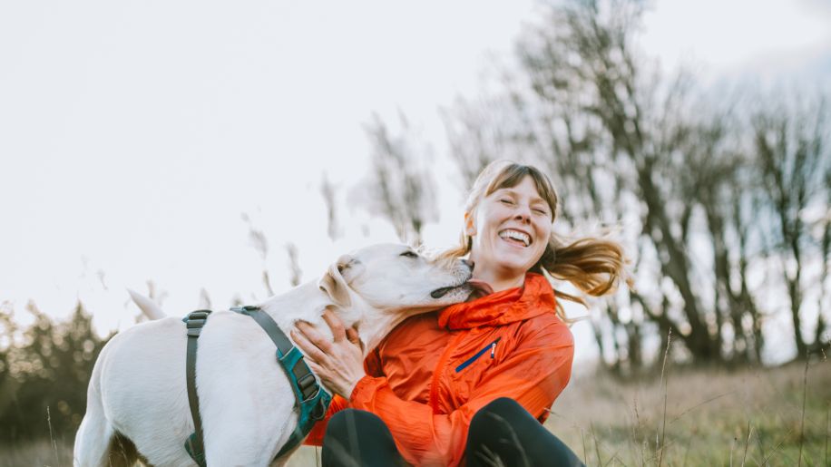 Middle aged woman and dog outdoors