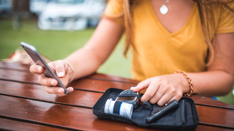 Woman taking blood glucose