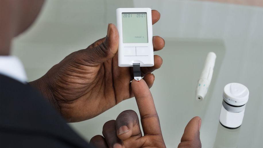 man checking his blood sugar levels