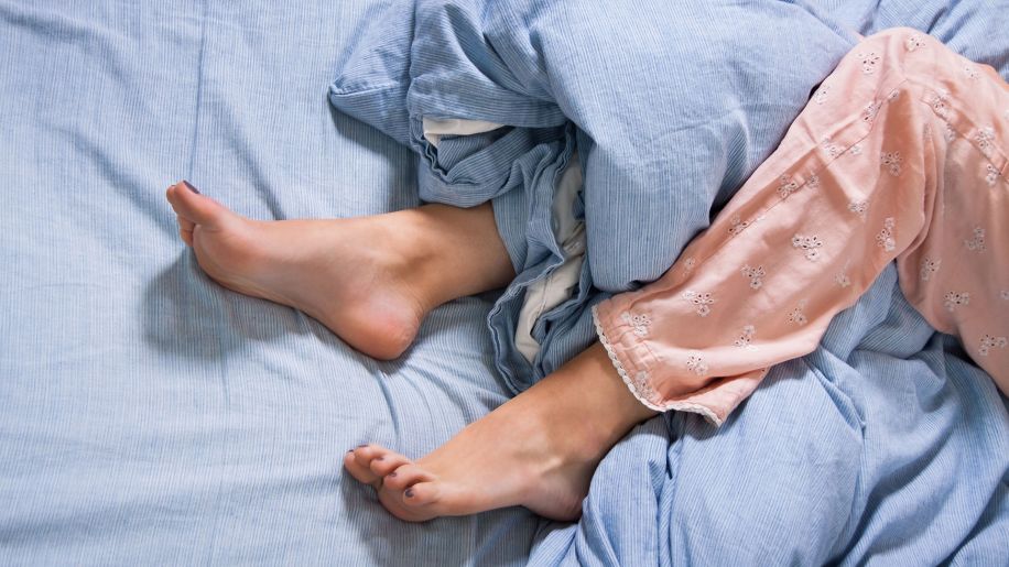 feet, bed, pajamas, blue sheets, restless sleep