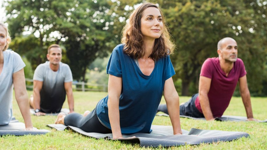 Group attends an outdoor yoga class.