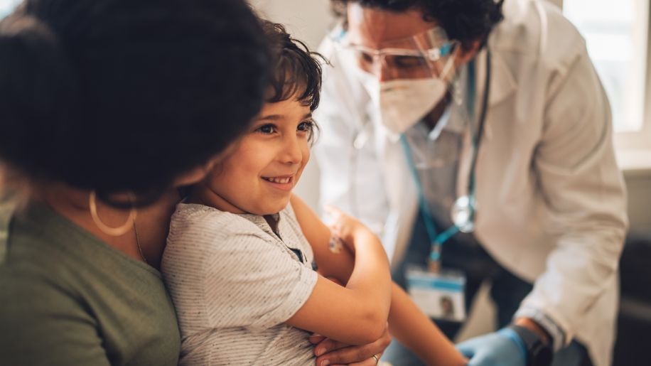 a child getting an MMR vaccine from a doctor