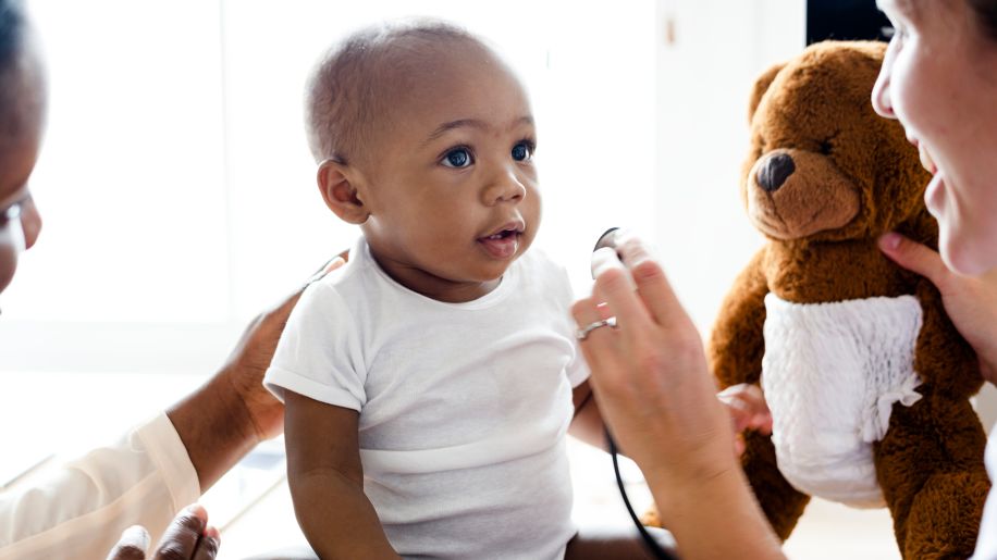a doctor interacting with a baby