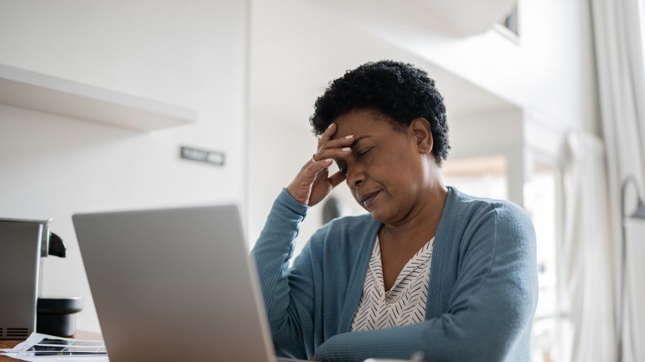 overwhelmed woman at desk 