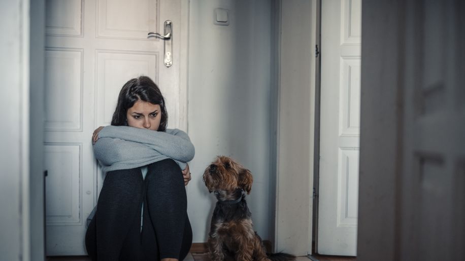 woman sad on the floor of a room