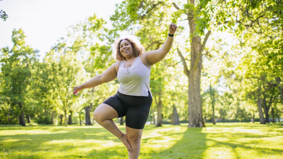 someone balancing on one foot in nature
