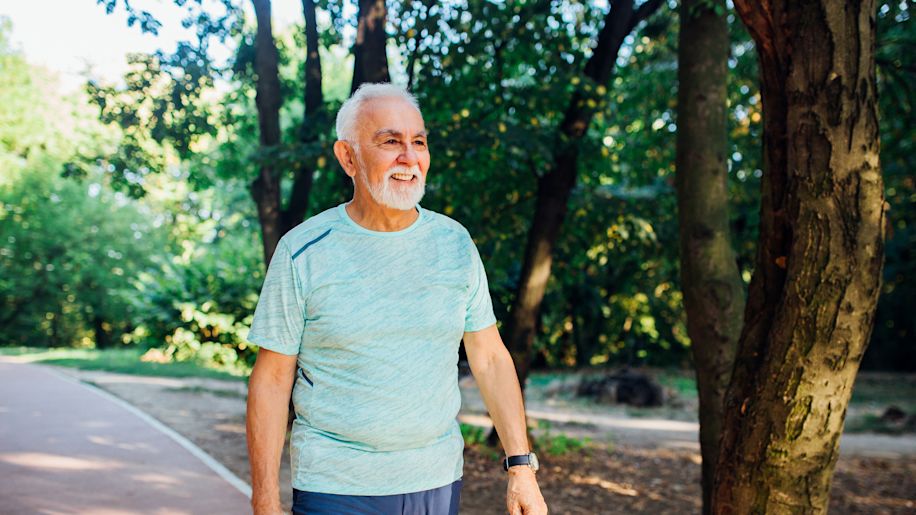 mature man walking in woods