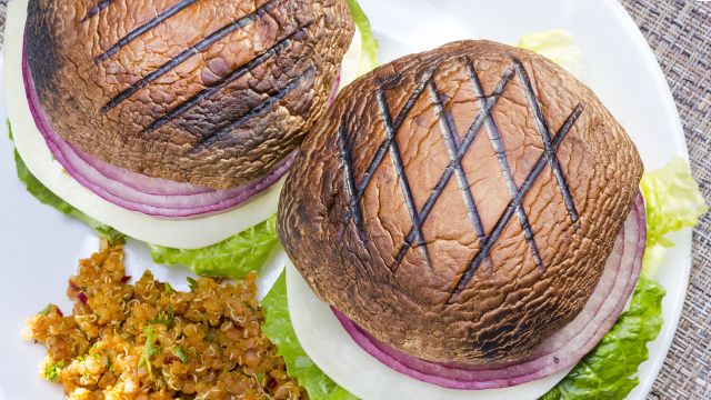 Grilled portabella vegetarian burger served with vegetables.