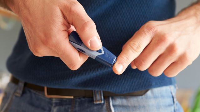 man checking his blood sugar