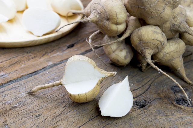 fresh cut jicama on wooden board