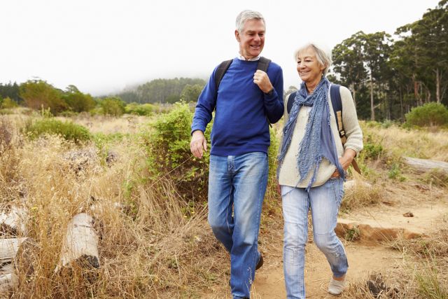 An older couple takes a walk. They know you can improve memory with walking and you can walk to increase brain size. 