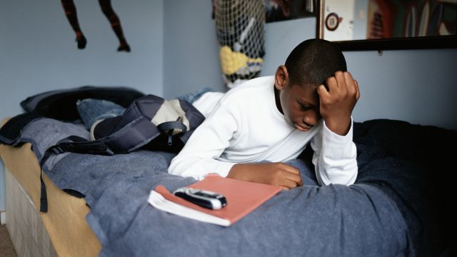 Worried boy lying on bed