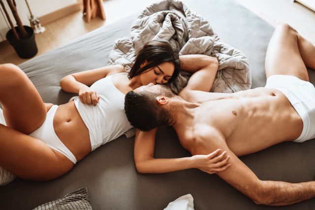 woman and man lying in bed, woman is unhappy