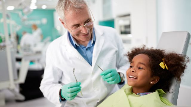 dentist with child patient in chair