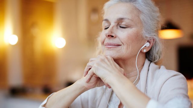 praying hands, mature woman, headphones, meditation