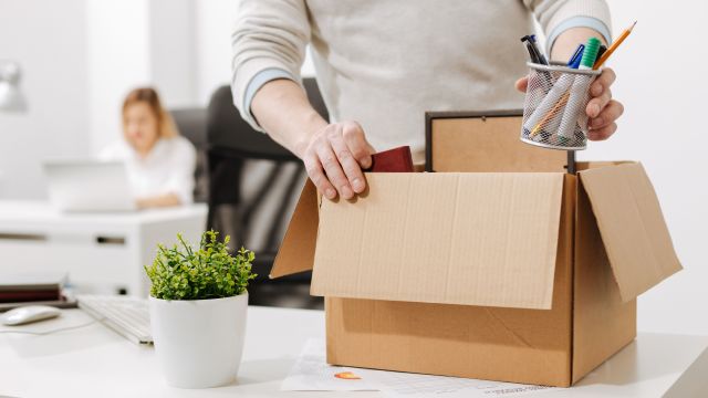 office employee packing up personal items and leaving job