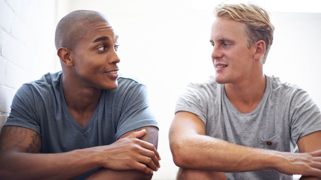 Two men sitting side by side