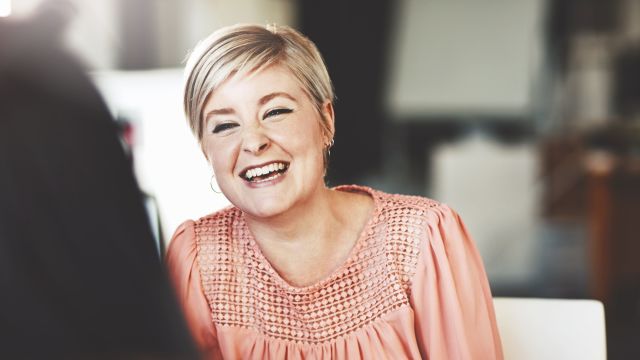 Woman laughing with a friend