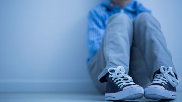 Lonely boy sitting alone