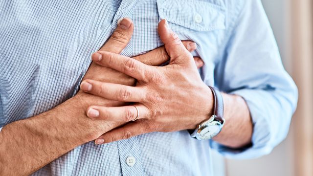 man holding chest