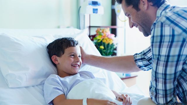 Father talking to young son before surgery
