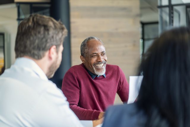 man smiling during work meeting