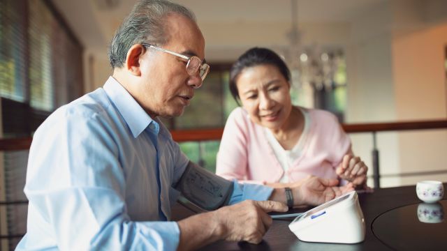 elderly asian man taking blood pressure