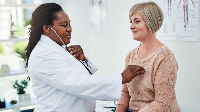 doctor checking heartbeat