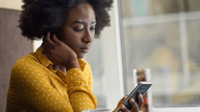 Woman looking worried staring at phone
