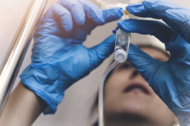 A healthcare provider sets up a chemotherapy infusion for a patient being treated for classical Hodgkin lymphoma.