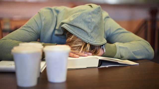 young woman sleeping on a book