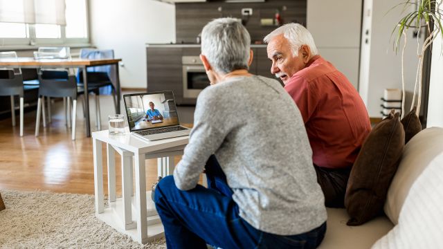 An older couple has a telemedicine conversation with their healthcare provider.