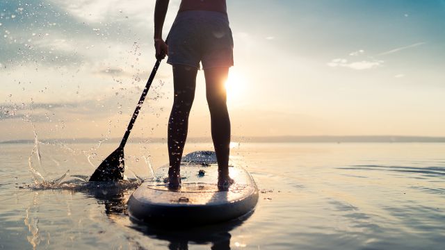A woman on a stand-up paddle board. 