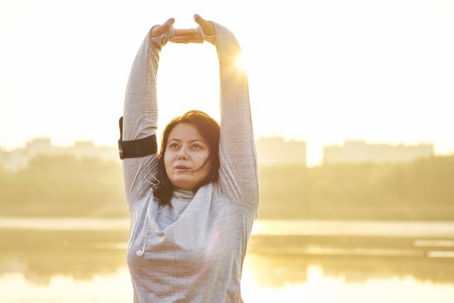 woman standing stretching