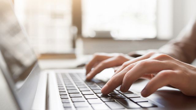 Hands typing on keyboard.