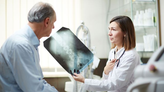 Doctor showing patient x-ray of lungs