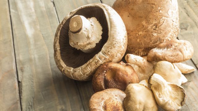 Anti-inflammatory mushrooms, loaded with natural health benefits, sit on a wooden surface, ready to eat.