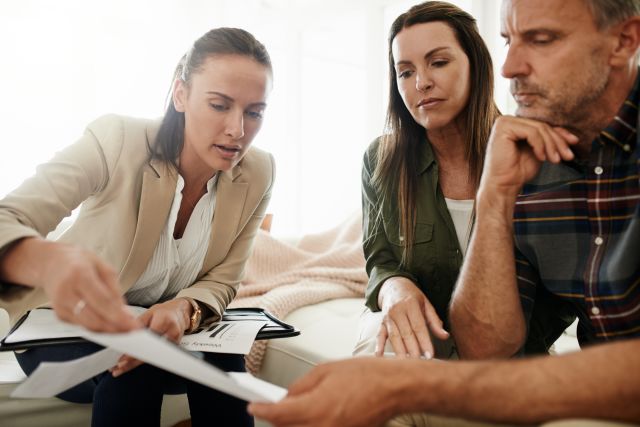 a couple discusses life insurance with a financial planner