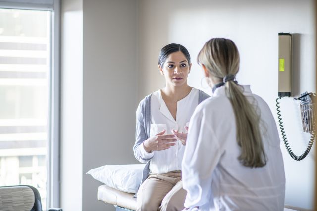 a female patient speaks with a female doctor