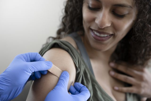 smiling woman receiving vaccine