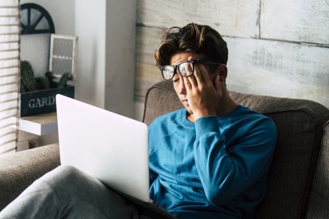 computer worker rubbing eyes