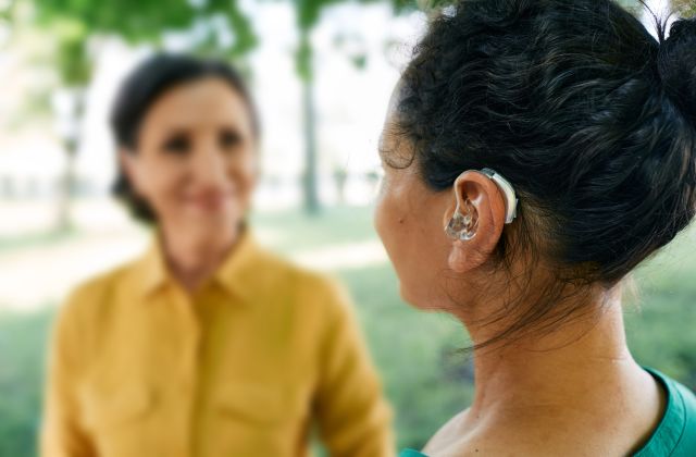 adult wearing a hearing aid