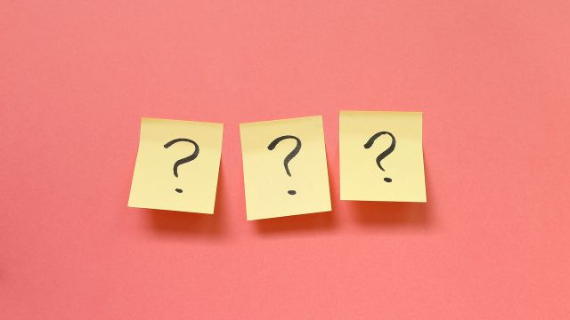 Three post it notes with question marks written on them. 