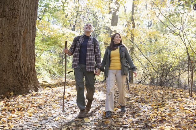 mature couple walking in woods